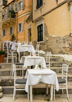 Tables and chairs of small neighborhood cafe in Kerkyra
