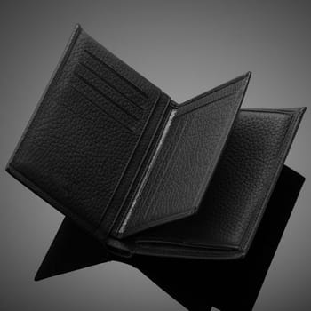 Fashionable designer leather men's wallet on a black background