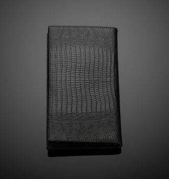 Fashionable leather men's wallet on a dark background