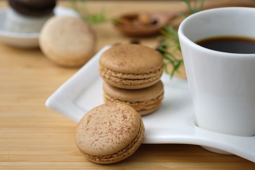 Chocolate and coffee macaroons  on wooden background, AF point selection, copy space for write.