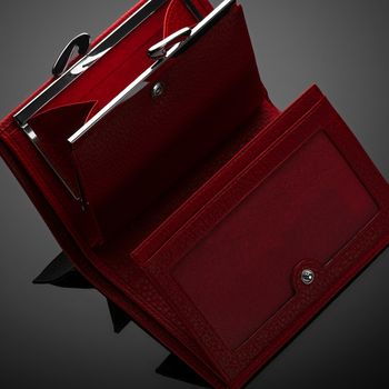 Fashionable red leather women's wallet on a dark background