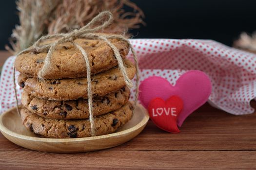 Chocolate chip cookies stacked up on a plate in low light, 
AF point selection