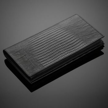 Fashionable leather men's wallet on a dark background