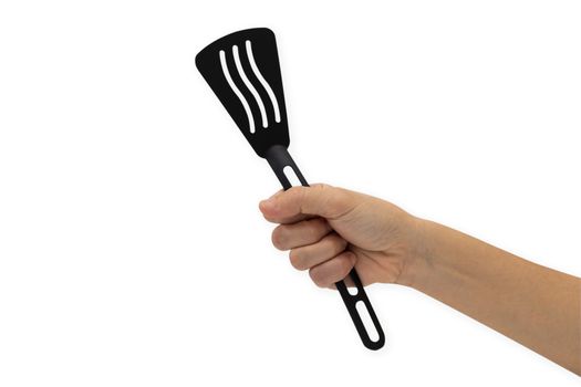 Hand holding a spatula isolated on a white background.