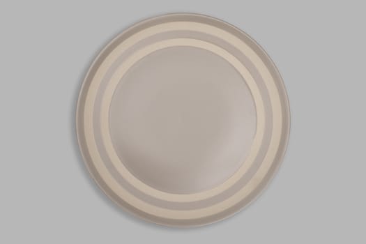 Top view-Empty brown ceeamic round dish plate isolated on grey background.