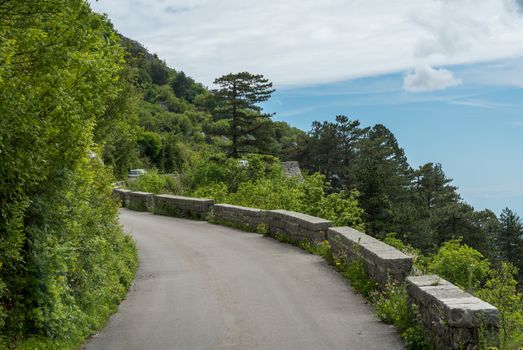 Cars on narrow Kotor Serpentine road with hairpin bends