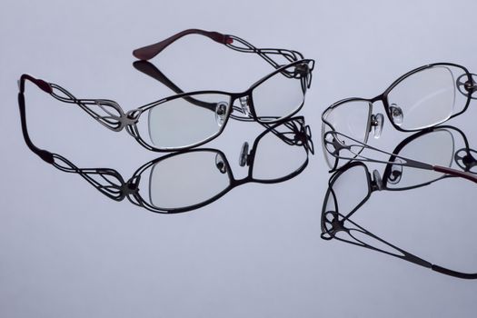 modern optical glasses on a dark surface with mirror reflection