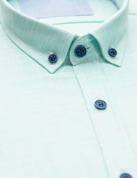 green shirt with a focus on the collar and button, close-up