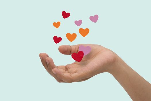 Flying hearts from hands, Valentine's Day, love concept, isolated blue background.