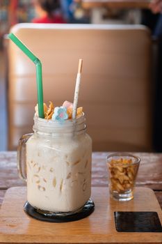 Milkshake with marshmallow, sweet  cookies, served in glass mason jar.