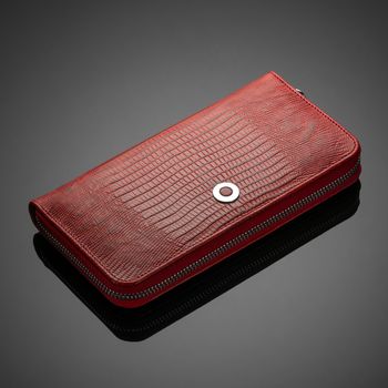Fashionable red leather women's wallet on a dark background