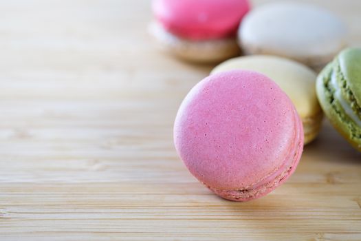 Sweet and colorful macaroons cookies on wooden background with blank space,selective focus, Dessert.