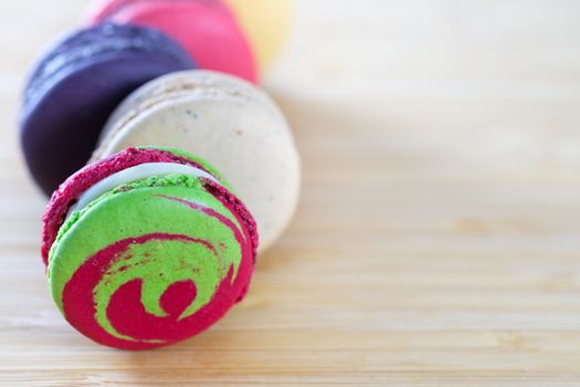 Sweet and colorful macaroons cookies on wooden background with blank space,selective focus, Dessert.