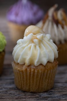 Tasty mini cupcakes on a vintage background, sweet dessert for christmas, new year and valentine holliday.