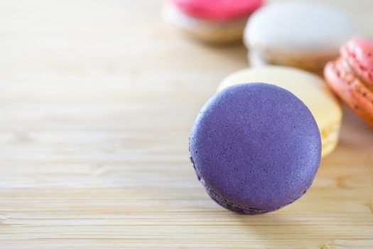 Sweet and colorful macaroons cookies on wooden background with blank space,selective focus, Dessert.