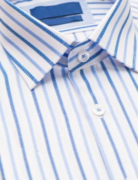 striped shirt with a focus on the collar and button, close-up