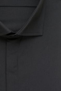 black shirt, detailed close-up collar and button, top view