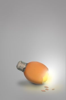 Contemporary art of lightbulb egg on grey background with copy space, Vertical image.