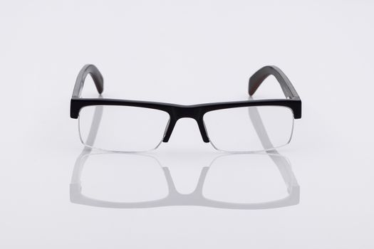 classic optical glasses on a light surface with reflection
