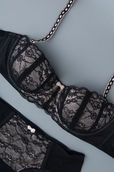 black lace female underwear on a gray background, top view