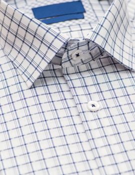 shirt with checkered pattern and with a focus on the collar and button, close-up