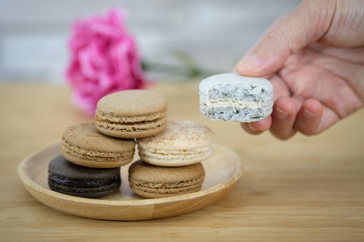 Chocolate, coffee macaroons on a  wooden table in warm light, Vintage tone.