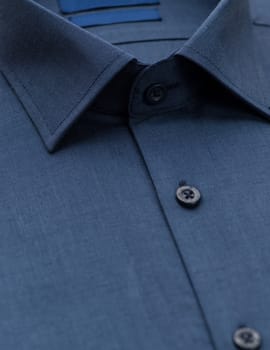 dark blue shirt with a focus on the collar and button, close-up
