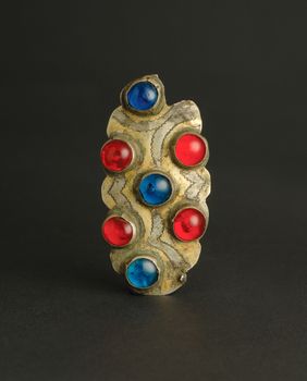 ancient antique brooch with stones on black background. Middle-Asian vintage jewelry