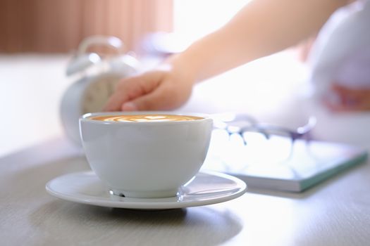 Women are drinking coffee on the bed in the morning.