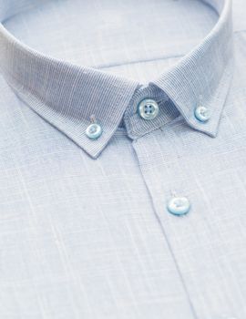 gray shirt with a focus on the collar and button, close-up