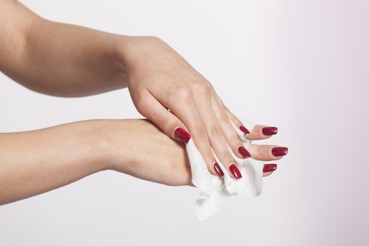 Young woman clean hands with wet wipes