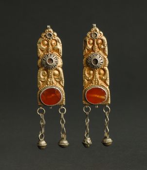 ancient antique earrings with stones on black background. Middle-Asian vintage jewelry