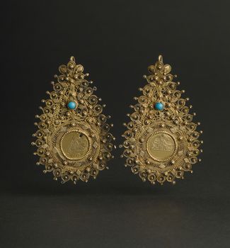 ancient antique earrings with stones on black background. Middle-Asian vintage jewelry