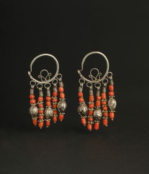 ancient antique earrings with stones on black background. Middle-Asian vintage jewelry