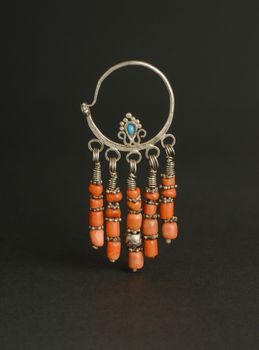 ancient antique earrings with stones on black background. Middle-Asian vintage jewelry