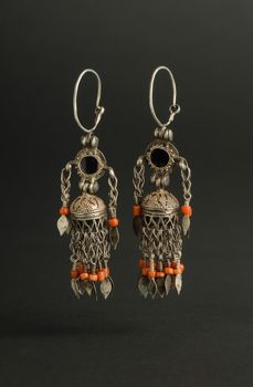 ancient antique earrings with stones on black background. Middle-Asian vintage jewelry