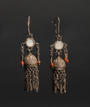 ancient antique earrings with stones on black background. Middle-Asian vintage jewelry