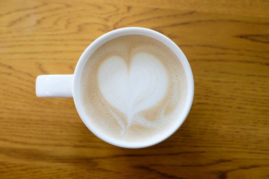 Hot cup of coffee, A heart-shaped milk froth, valentine concept.