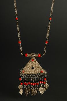 ancient antique pendant with stones on black background. Middle-Asian vintage jewelry