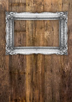 Old Picture Frame on wood baclground, white inside