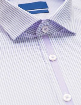 purple shirt with focus on collar and button, close-up