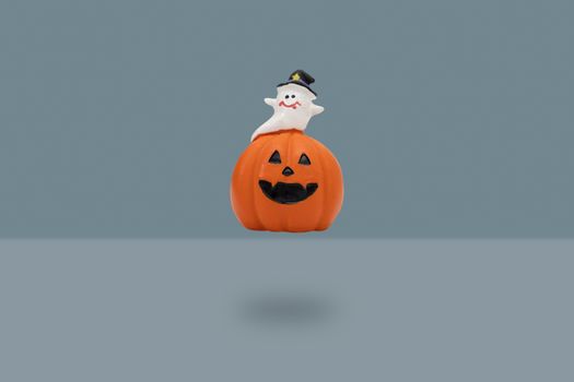 Halloween pumpkin on blue background. Halloween idea concept.