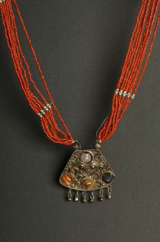 ancient antique pendant with stones on black background. Middle-Asian vintage jewelry