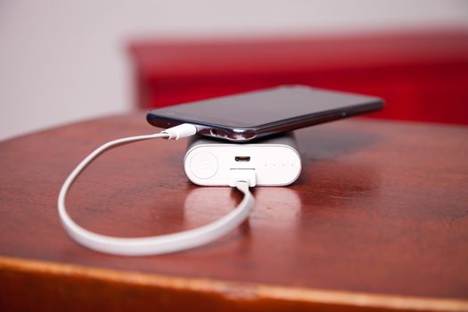 Mobile Phone Charging With Power Bank and usb cord on table