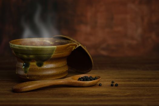 Still life pottery cups with hot soup and smoke on rustic wooden table, Choose a focal point.