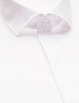 white shirt with focus on collar and button, close-up