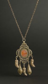 ancient antique pendant with stones on black background. Middle-Asian vintage jewelry