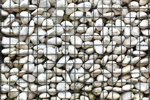 texture of stone wall white stone background. cobblestone or abstract background with dry round reeble stones