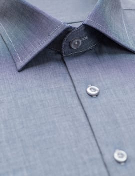 blue shirt with a focus on the collar and button, close-up