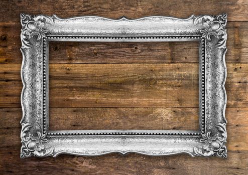 Old Picture Frame on wooden baclground wall, silver metal